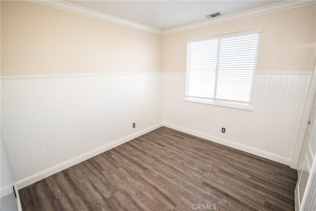 unfurnished room featuring dark hardwood / wood-style floors and ornamental molding