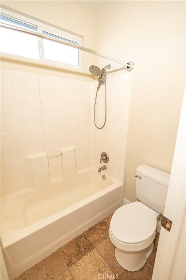 110 Montage Dr, Merced, CA 95348 - bathroom with toilet, shower / washtub combination, and stone tile floors