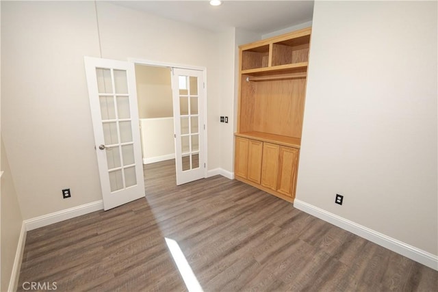 interior space with dark hardwood / wood-style floors and french doors