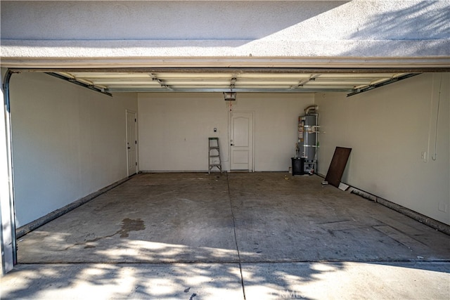 garage featuring strapped water heater and a garage door opener