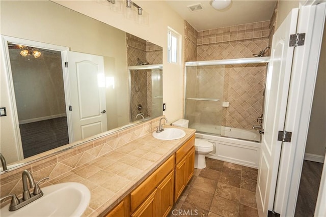110 Montage Dr, Merced, CA 95348 - full bath with double vanity, toilet, enclosed tub / shower combo, and tasteful backsplash
