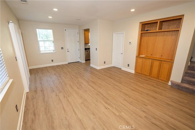 110 Montage Dr, Merced, CA 95348 - unfurnished living room with light wood-style floors, stairs, recessed lighting, and baseboards