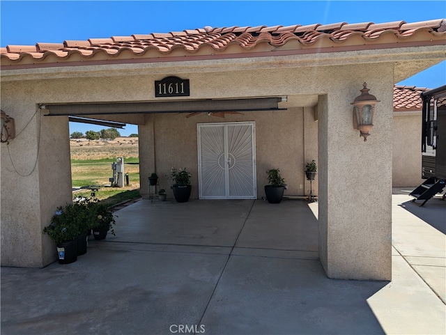 doorway to property with a patio area