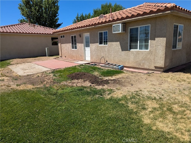 rear view of house featuring a patio area and a yard