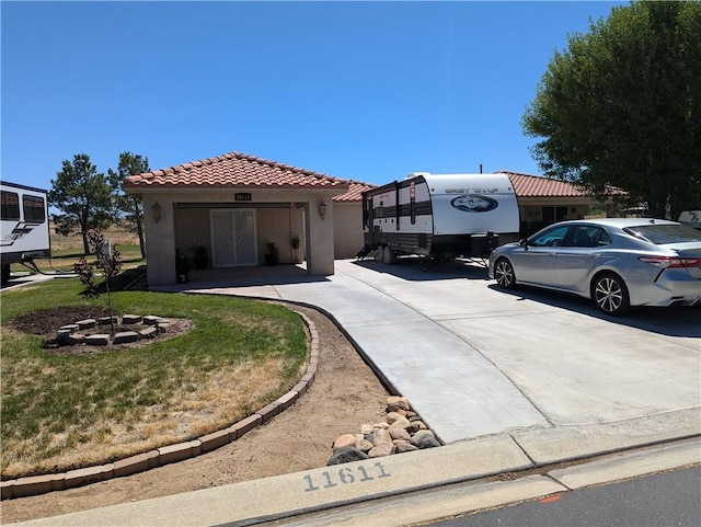 11611 Ridgemark Rd, Apple Valley, CA 92308 - mediterranean / spanish house featuring stucco siding, a tile roof, driveway, and a garage