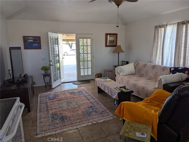 tiled living room with lofted ceiling, ceiling fan, and french doors