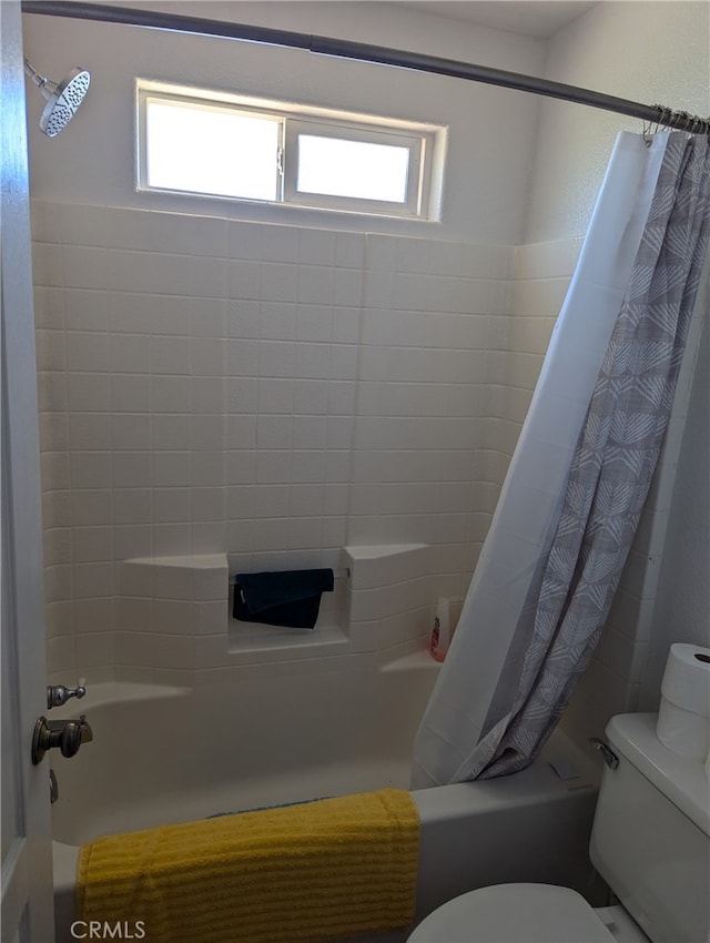 bathroom with toilet and shower / bath combo with shower curtain