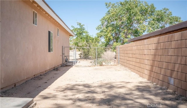 view of property exterior with a patio and fence