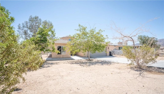 view of front of home featuring concrete driveway and stucco siding
