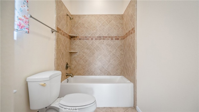 bathroom featuring tiled shower / bath combo and toilet