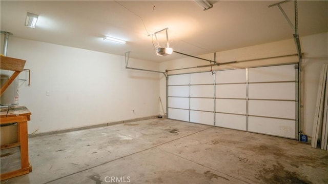 garage with baseboards and a garage door opener