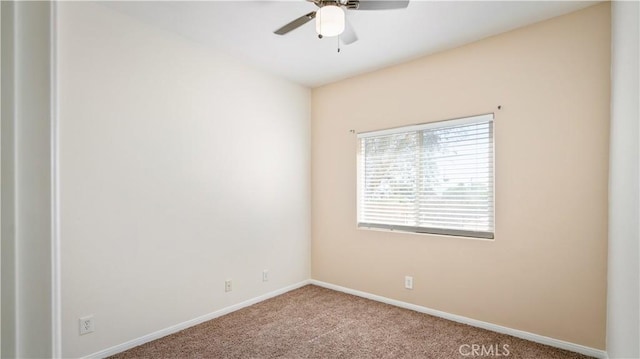empty room featuring baseboards, a ceiling fan, and carpet flooring