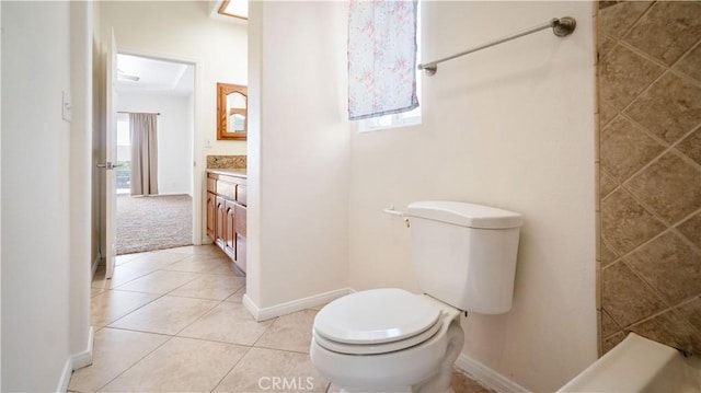 bathroom featuring baseboards, vanity, tile patterned flooring, and toilet