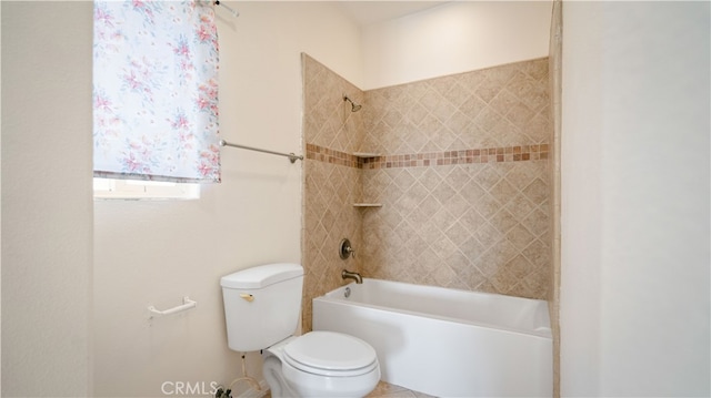 bathroom with tiled shower / bath combo and toilet