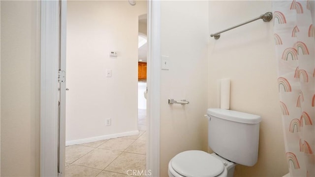 bathroom with toilet and tile patterned floors