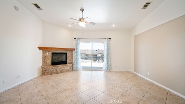 unfurnished living room with a high end fireplace, light tile patterned floors, and ceiling fan