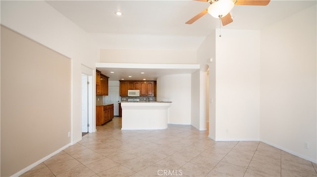 unfurnished living room with light tile patterned floors and ceiling fan