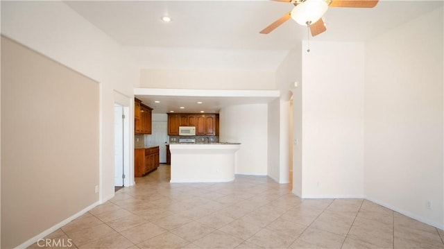 unfurnished living room featuring a ceiling fan, baseboards, recessed lighting, and light tile patterned flooring