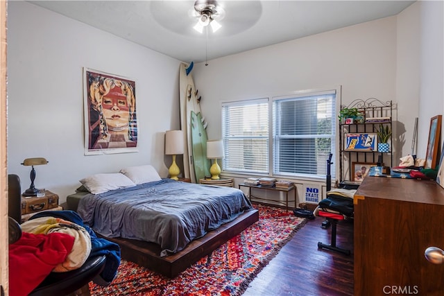 bedroom with ceiling fan and dark hardwood / wood-style flooring