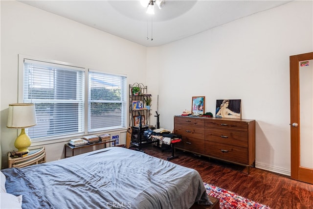 bedroom with ceiling fan and dark wood-type flooring