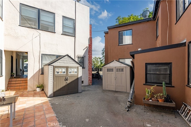 exterior space featuring a shed and a patio area