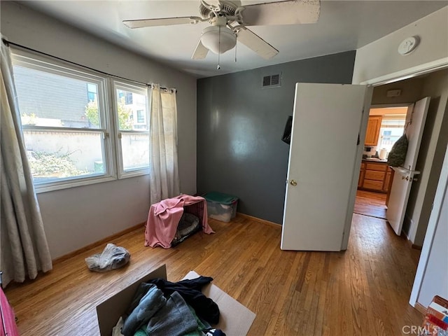 miscellaneous room with ceiling fan and light hardwood / wood-style floors