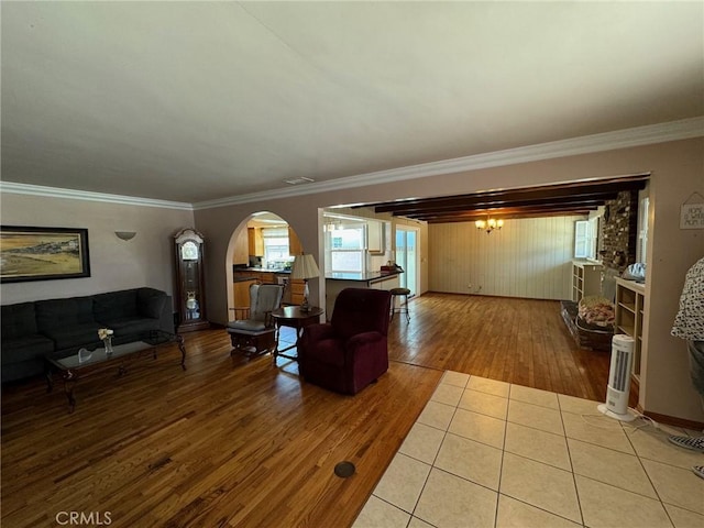 living room featuring ornamental molding and light tile patterned flooring