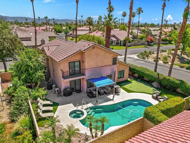 view of swimming pool with an in ground hot tub and a patio area