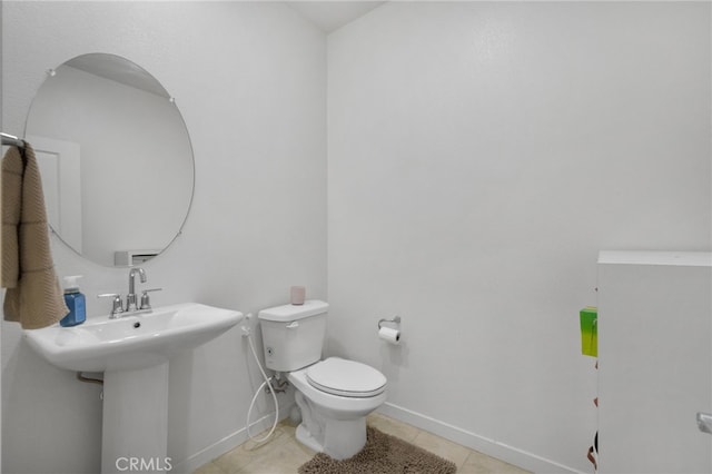 3570 E Peckham Paseo Unit 3, Ontario, CA 91761 - half bath featuring baseboards, a sink, tile patterned floors, and toilet