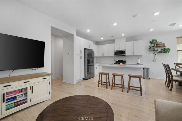 3570 E Peckham Paseo Unit 3, Ontario, CA 91761 - living area featuring light wood-style floors, baseboards, recessed lighting, and visible vents