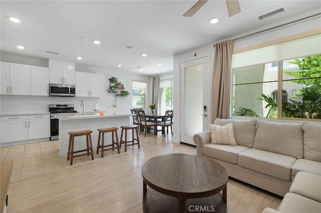 3570 E Peckham Paseo Unit 3, Ontario, CA 91761 - living room with recessed lighting, ceiling fan, visible vents, and light wood-type flooring