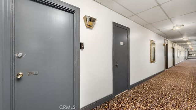 hall with a paneled ceiling