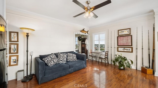 living room featuring crown molding, ceiling fan, and dark hardwood / wood-style flooring