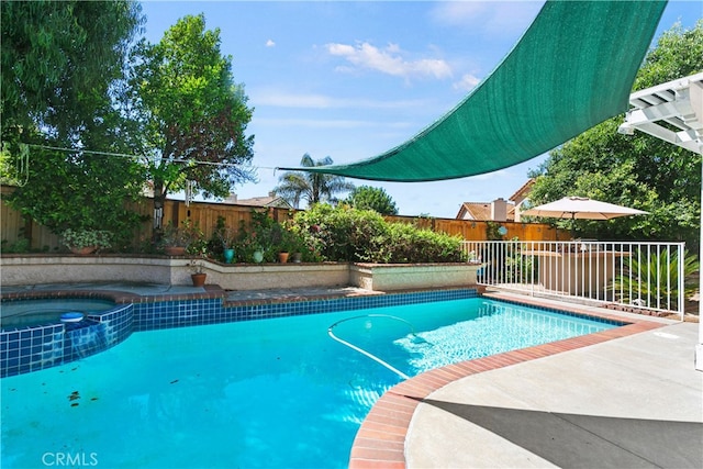 view of swimming pool featuring an in ground hot tub