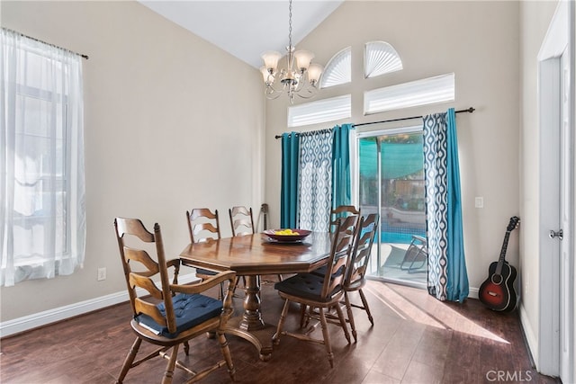 dining space featuring vaulted ceiling, dark hardwood / wood-style floors, and an inviting chandelier