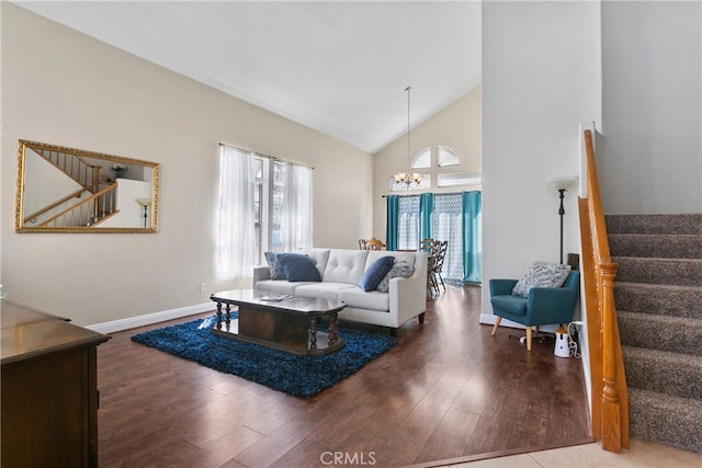 living room featuring high vaulted ceiling, wood-type flooring, and a notable chandelier