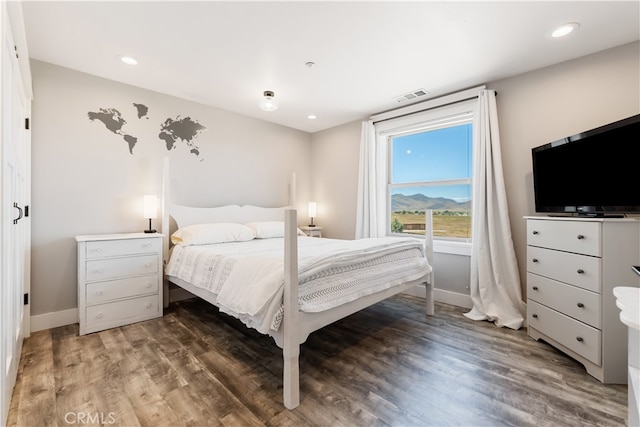 bedroom with dark hardwood / wood-style flooring