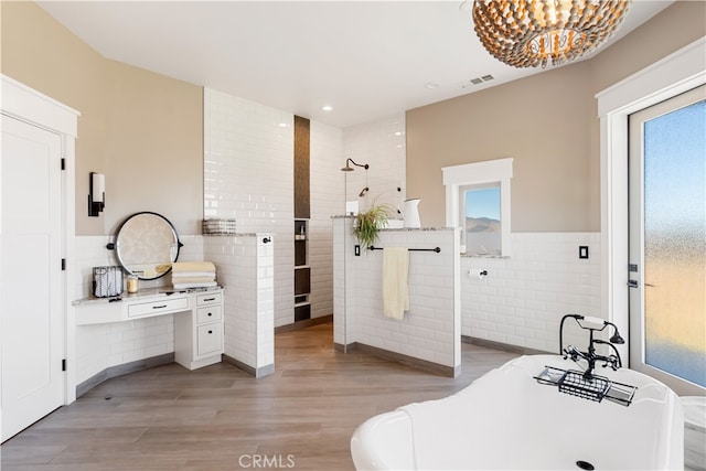 bathroom with tile walls, plus walk in shower, hardwood / wood-style flooring, and a healthy amount of sunlight