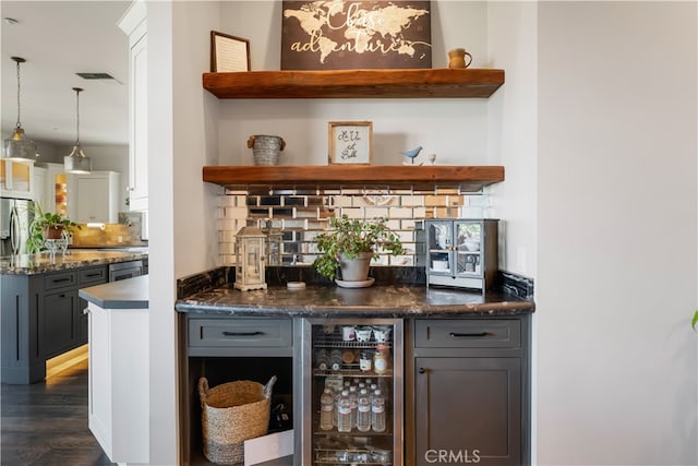 bar with wine cooler, backsplash, dark hardwood / wood-style floors, pendant lighting, and gray cabinetry