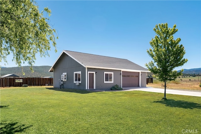 ranch-style home with a garage and a front lawn