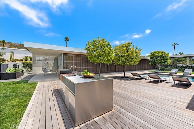 wooden terrace featuring area for grilling and a patio area