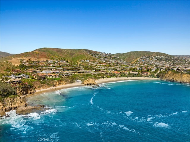 exterior space featuring a water and mountain view and a beach view