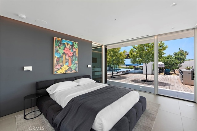 tiled bedroom featuring access to outside and expansive windows