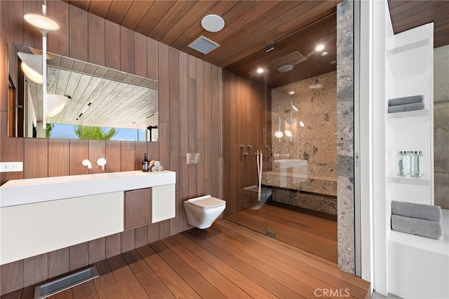 bathroom with vanity, wood-type flooring, wooden walls, wooden ceiling, and toilet