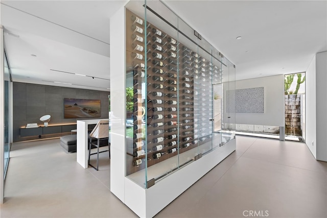 wine area with expansive windows and concrete flooring