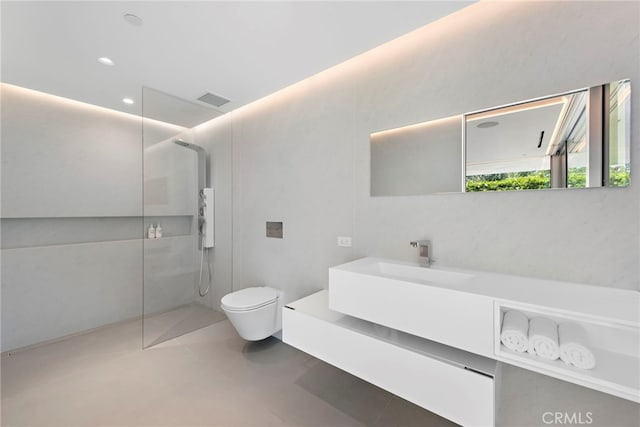 bathroom featuring a shower, vanity, and toilet