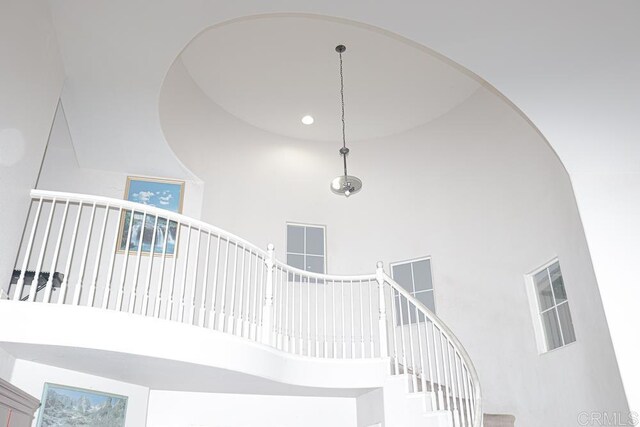 staircase with a high ceiling