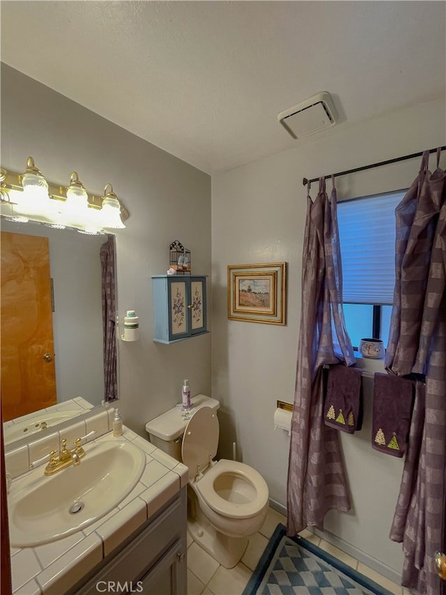 bathroom with vanity, toilet, and tile patterned floors