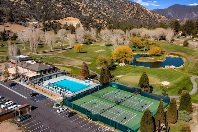 birds eye view of property with a water and mountain view