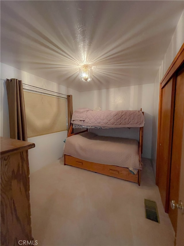 carpeted bedroom with a closet